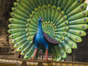 Close up of colorful statue of peacock in Batu Cave temple that is one of the most renowned Hinde shrines located outside of India which is dedicated to the Lord Murugan,