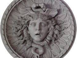 Medusa architectural decoration in a circular frame. The image is isolated on white.