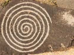 Spiral circle of life petroglyph. Ancient Pueblo etching located at Petroglyph National Monument, Albuquerque, New Mexico.